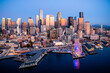 © Open Range Studios/Stocksy - Seattle Waterfront Skyline Illuminated at Sunset