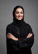 © Zubair - Elegant Emirati woman smiling confidently in traditional abaya with folded arms