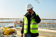 © Ivan Jovanovic/Stocksy - Civil engineer makes a phone call