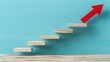 © Oleg - Abstract business growth concept with blue background, red arrow, and wooden stairs for success