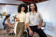 © Jimena Roquero/Stocksy - Portrait of young entrepreneurs in office smiling at camera
