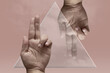 © Evgeniy Shvets/Stocksy - Collage with a glass triangle and two male hands