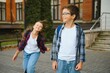 © Serhii - School friends, a boy and a girl spend time together near the school. Back to school