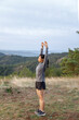 © Jovo Jovanovic/Stocksy - Fit woman doing warm-up exercise on mountain