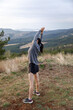 © Jovo Jovanovic/Stocksy - Woman doing warm-up exercise on mountain