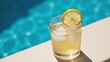 © Pixel Matrix - A refreshing cocktail sits on a poolside amidst clear blue waters and sunshine symbolizing a carefree summer getaway