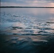 © Kat Schleicher/Stocksy - Ripples on Frozen Lake at Dusk