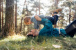 © Santi Nuñez/Stocksy - Parent and child playing in the forest sunlight