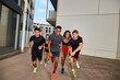 © Javier Díez/Stocksy - Group of athlete friends having fun on street