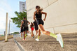 © Javier Díez/Stocksy - Runners sprint in an urban area