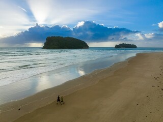 Wall Mural - Couple walks along a beach at sunrise, peaceful morning stroll. , Whangamata, Coromandel Peninsula, NZ