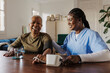 © BONNINSTUDIO/Stocksy - Nurse checking blood pressure of happy senior woman at home