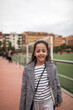 © Lupe Rodriguez/Stocksy - girl on a soccer field watching the game
