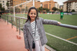 © Lupe Rodriguez/Stocksy - girl on a soccer field watching the game