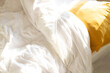 © Colour Laboratory/Stocksy - View of bed with sheets, duvet, pillow and cushions with soft sunlight