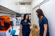 © VICTOR TORRES/Stocksy - Health personnel sharing a light moment in a laboratory setting