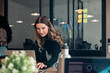 © Santi Nuñez/Stocksy - Focused professional woman working on a laptop in an office