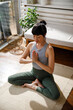 © Jovo Jovanovic/Stocksy - High angle view of active woman meditating at home
