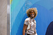 © VICTOR TORRES/Stocksy - Vibrant Colombian gay man Smiling Against Blue Artistic Wall