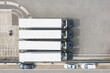 © Lawren Lu/Stocksy - Aerial View of Trucks Parked in a Transportation Logistics Area