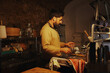© Tani Nekrasova/Stocksy - Mature adult man washing dishes and clean up in a kitchen at home