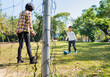 © Lawren Lu/Stocksy - Child Playing Soccer in a Park with Mother Supervision