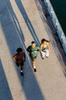 © Adrian Rodd/Stocksy - Friends enjoy a jogging practice near a lake on a sunny autumn morning