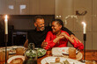 © BONNINSTUDIO/Stocksy - Happy couple enjoying christmas dinner at home