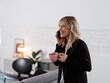© B Krokodil/Stocksy - Smiling Professional Woman Holding Coffee Mug While Talking On Phone