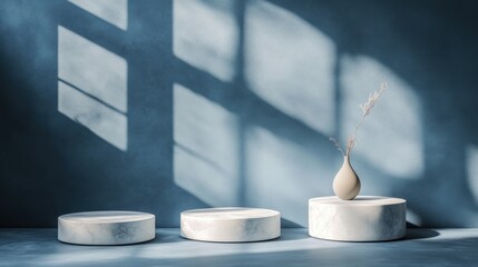 Sticker - Three marble podiums with vase and plant, sunlit blue wall.