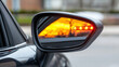 © Jirapron - close up of car side mirror reflecting vibrant sunset glow