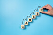 © Kenishirotie - Career progression, illustrated with wooden blocks forming the word CAREER, arranged in ascending order with a growth curve drawn over them on a blue background