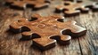 © Creative_art - A close-up of wooden puzzle pieces on a rustic wooden surface.