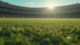 close up view of soccer field with lush green grass, illuminated by sun setting in background, creating vibrant atmosphere in stadium