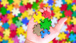 © Cody - Autism awareness concept with hand of puzzle pieces as symbol of autism.