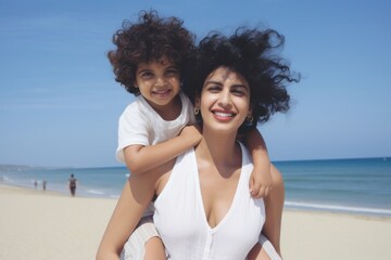 Sticker - Indian mom piggyback baby on a beach photography laughing portrait.