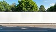 © Pete - Empty white hoarding stands on city street. Green trees line up behind blank billboard. Urban setting. Ideal for advertising. Modern structure. Blank space ready for poster. Potential for