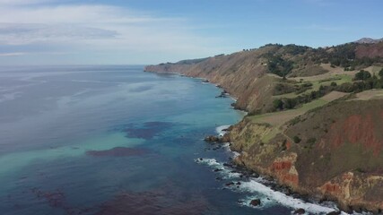 Wall Mural - Aerial view of Pacific Ocean coastline along Highway 1 in California. Big Sur, Bixby Bridge, Lucia. Travel concept, tourism, travel, vacation. 4K video.