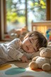 © fahmy - A toddler sleeps soundly on a cushioned mat with a small stuffed animal nearby