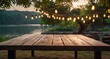 © HasibulAlam - Empty Wood table top with decorative outdoor string lights hanging on trees in the revier nature at sunset time,