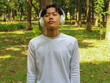© Lailar Studio - Young Asian man relax in nature & enjoying good music