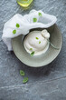 © Nickola_Che - Bowl with freshly made burrata cheese and green basil, vertical shot on a dark-grey granite background, above view