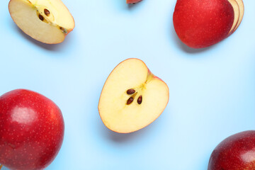 Wall Mural - Fresh ripe red apples on light blue background, flat lay