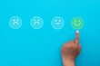 © Pakorn - Customer service Satisfication,Survey,evaluation concept.,Hand pointing smile face idea for customer feedback review.