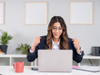 © Designerant - Excited businesswoman, portrait of young caucasian brunette happy excited businesswoman sit desk at office feel euphoric win online using looking laptop screen, promoted at work, amazed read good news