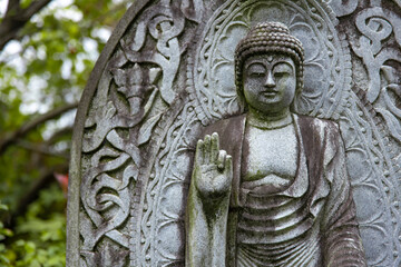 Wall Mural - A religious stone statue of Amitabha Buddha at Japanese buddhism temple