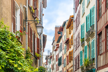 Wall Mural - Half-timbered residential building with colored shutters in Bayonne, France