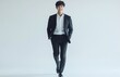 © yevgeniya131988 - Confident Asian young man in suit walking and smiling outdoors