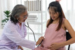 © pixs4u - Female senior doctor use stethoscope listening sound of baby in pregnant belly