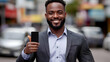 © Siasart - Smiling Businessman Shows Phone Screen and Gives Thumbs Up in City Street